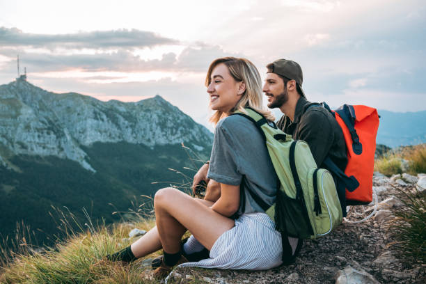 young couple of hikers with their hiking backpack